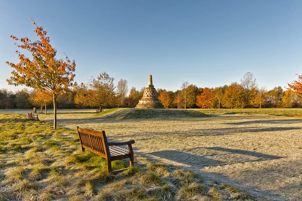 Image of bench in hemel hempstead in a nice empty, hilly field on a cold morning with blue skies