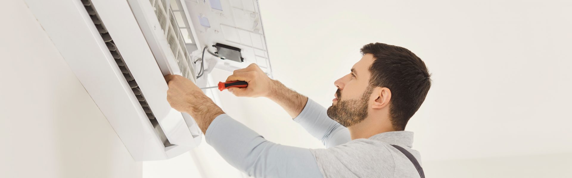man working on air conditioning unit